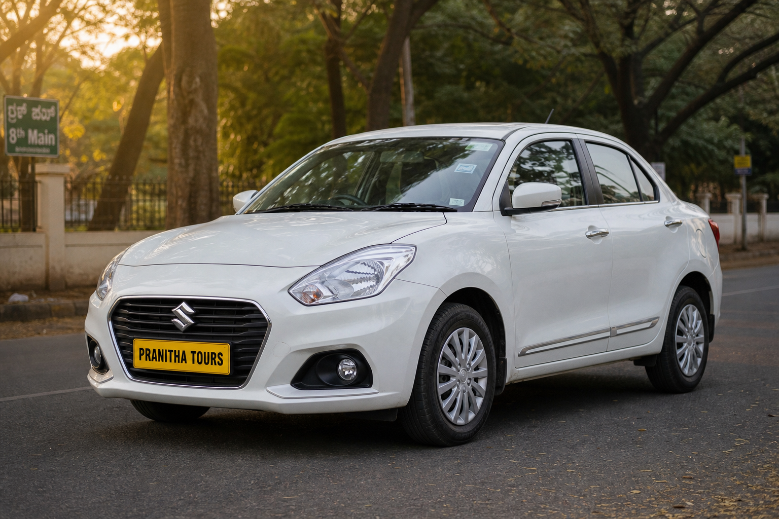 Maruti Swift Dzire sedan with Pranitha Tours yellow plate on a Bengaluru street