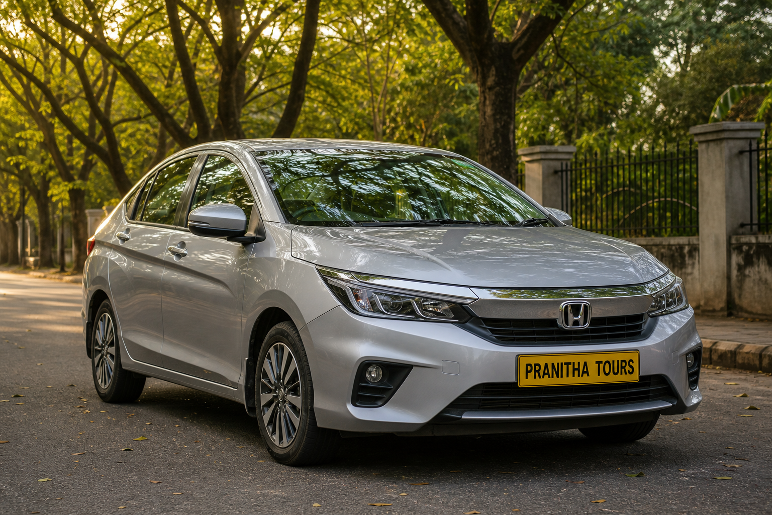 Honda City sedan with Pranitha Tours yellow plate near a Bengaluru tech park